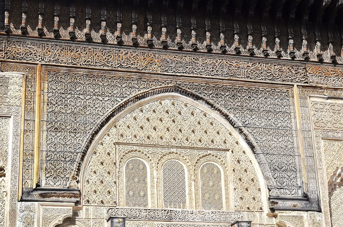 Fes Travel Guide: The Imperial City Handbook (2026) 3 Carved cedar and zellige interior courtyard of Medersa Bou Inania in Fes