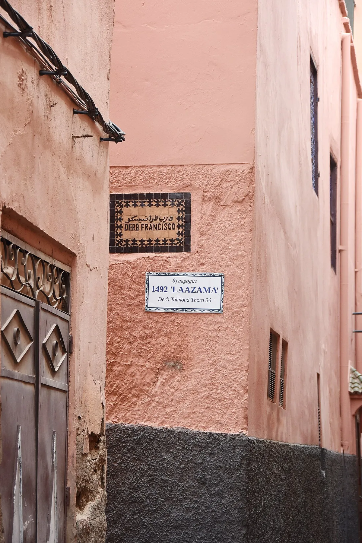 Narrow alleyway in the Mellah of Marrakech with balconies opening onto the street