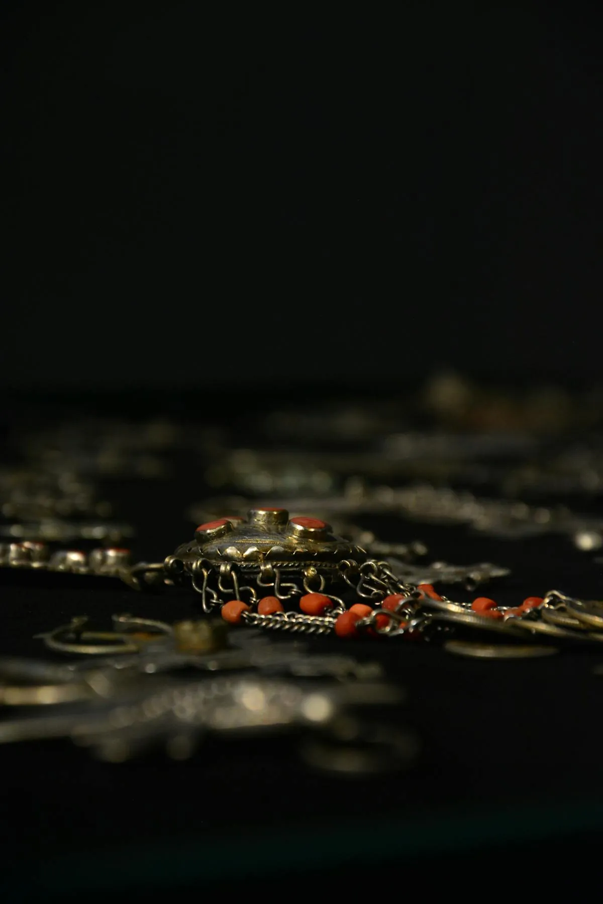 Close-up of traditional Moroccan Berber jewellery on display, evoking the Musée MAP collection in Marrakech